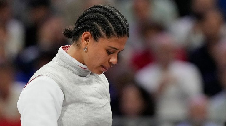 French Olympic fencer's kiss contamination defense holds up in court as she's cleared of doping violation