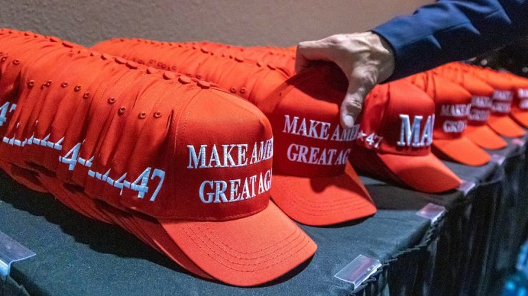 Fan wearing 'Make America Great Again' hat escorted by security from MLS match