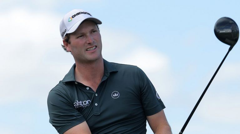 Alligator keeps close eye on PGA Tour golfer Vince Whaley while he takes swing near water