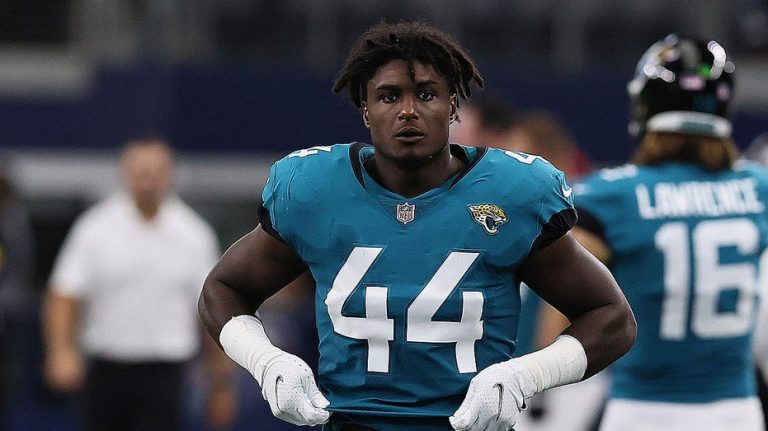 Former NFL standout climbed out of second-story window, fell before facing gun charges, police say